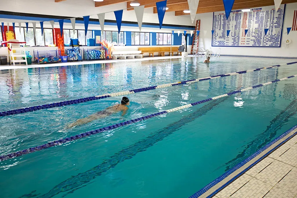 A U N E student swims in the Campus Center pool