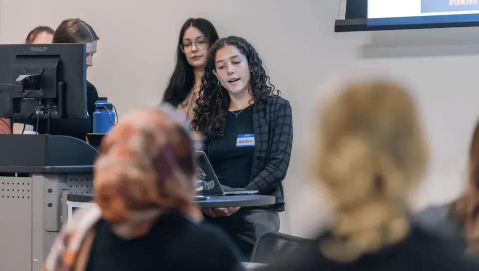 A group of students gives a slideshow presentation